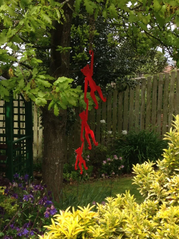 hanging monkeys garden sculpture - red