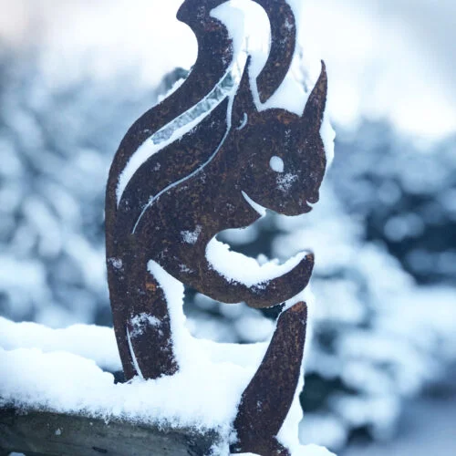 red squirrel sculpture in snow